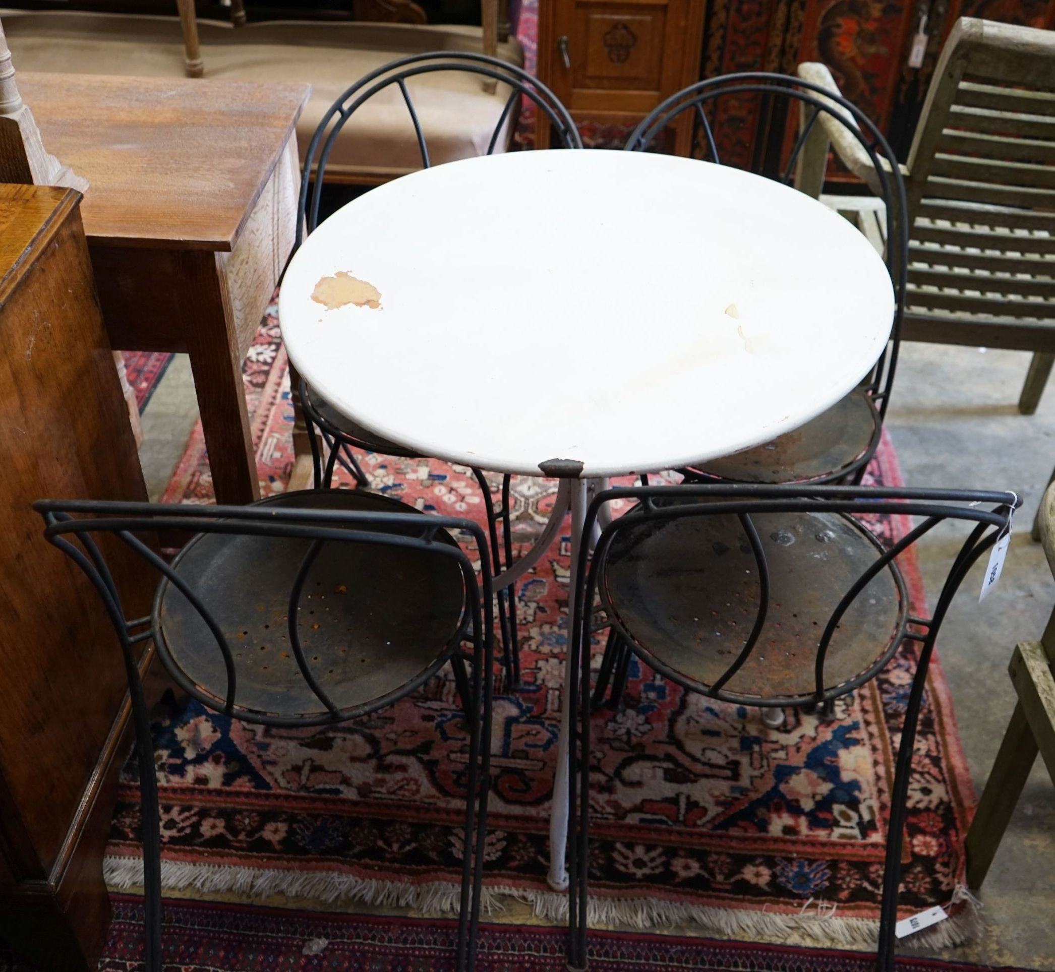 A circular metal garden table, diameter 70cm, height 76cm and four chairs